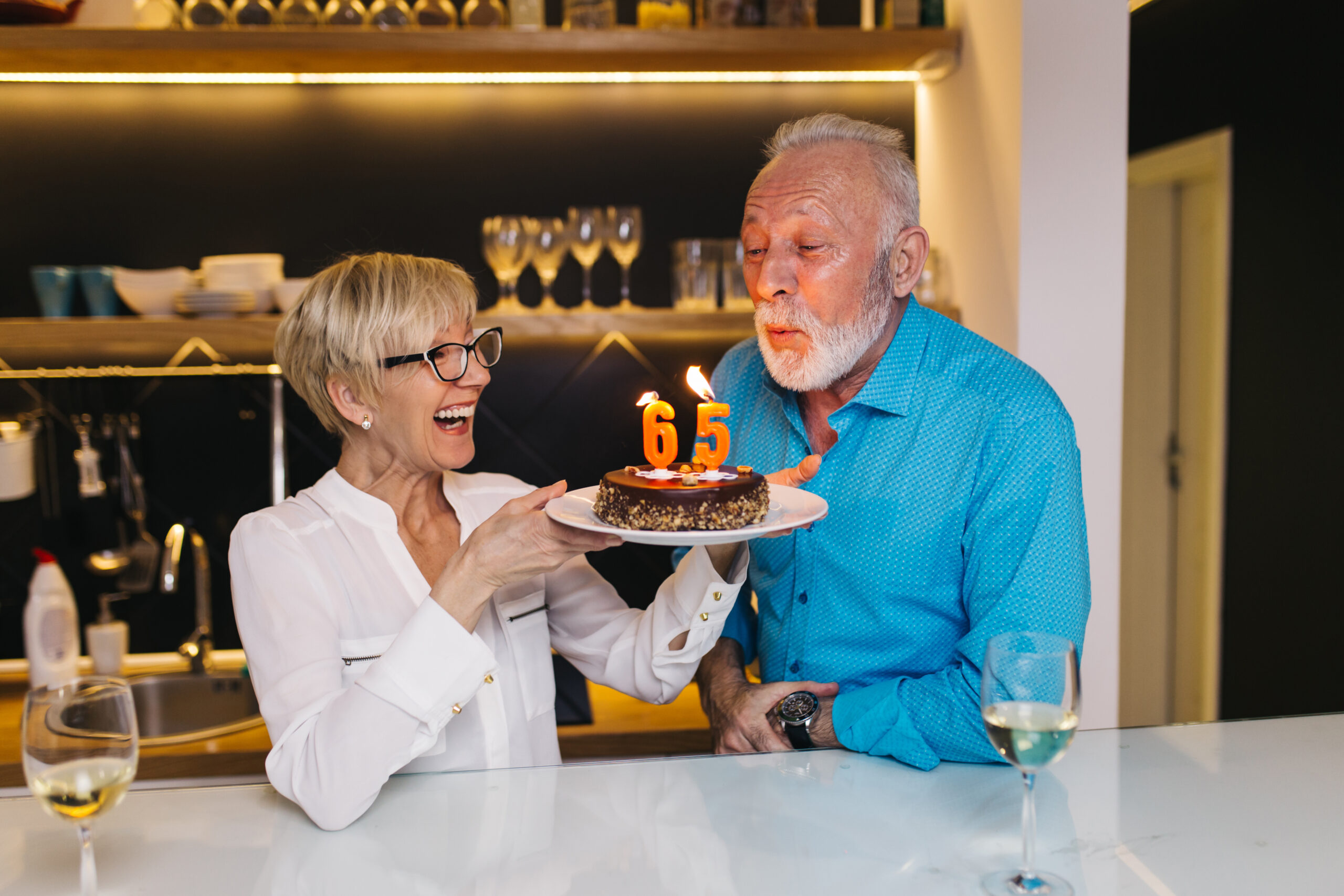 Happy senior couple celebrating birthday together.